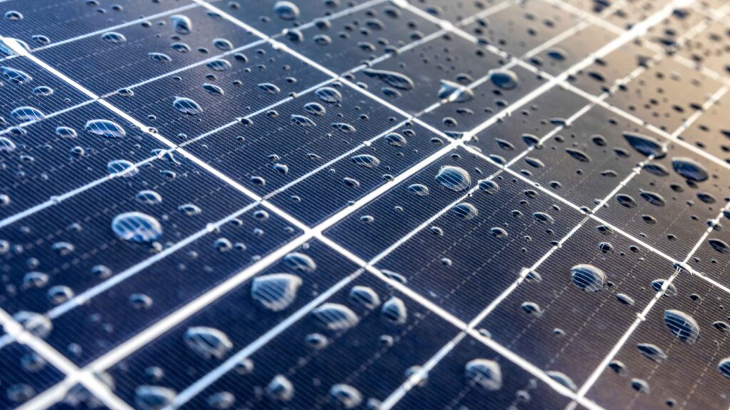 water droplets on solar panel installed by solar pros reflect the solar energy contribution to water conservation