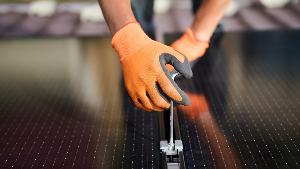 solar panel installer mesasuring the energy a home is producing